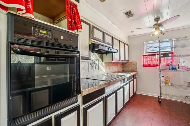 a kitchen with stainless steel appliances and stove