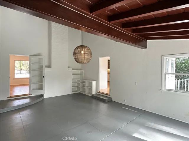 a view of a room with wooden floor and a window
