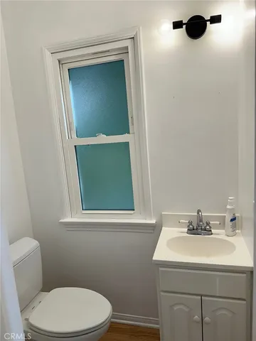 a bathroom with a sink a toilet and mirror