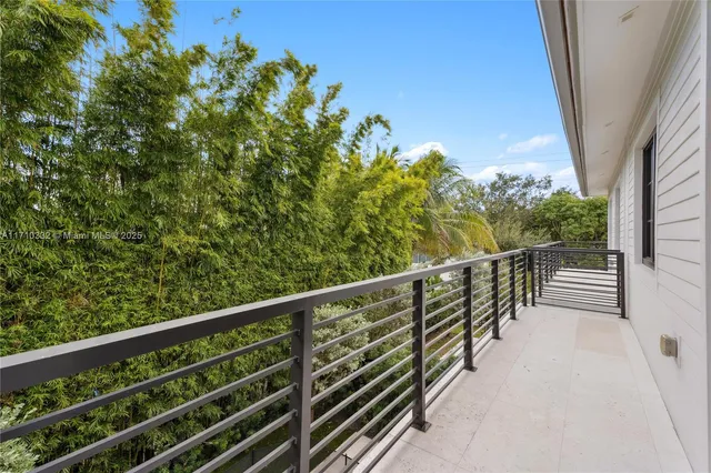 a balcony with trees in front of it