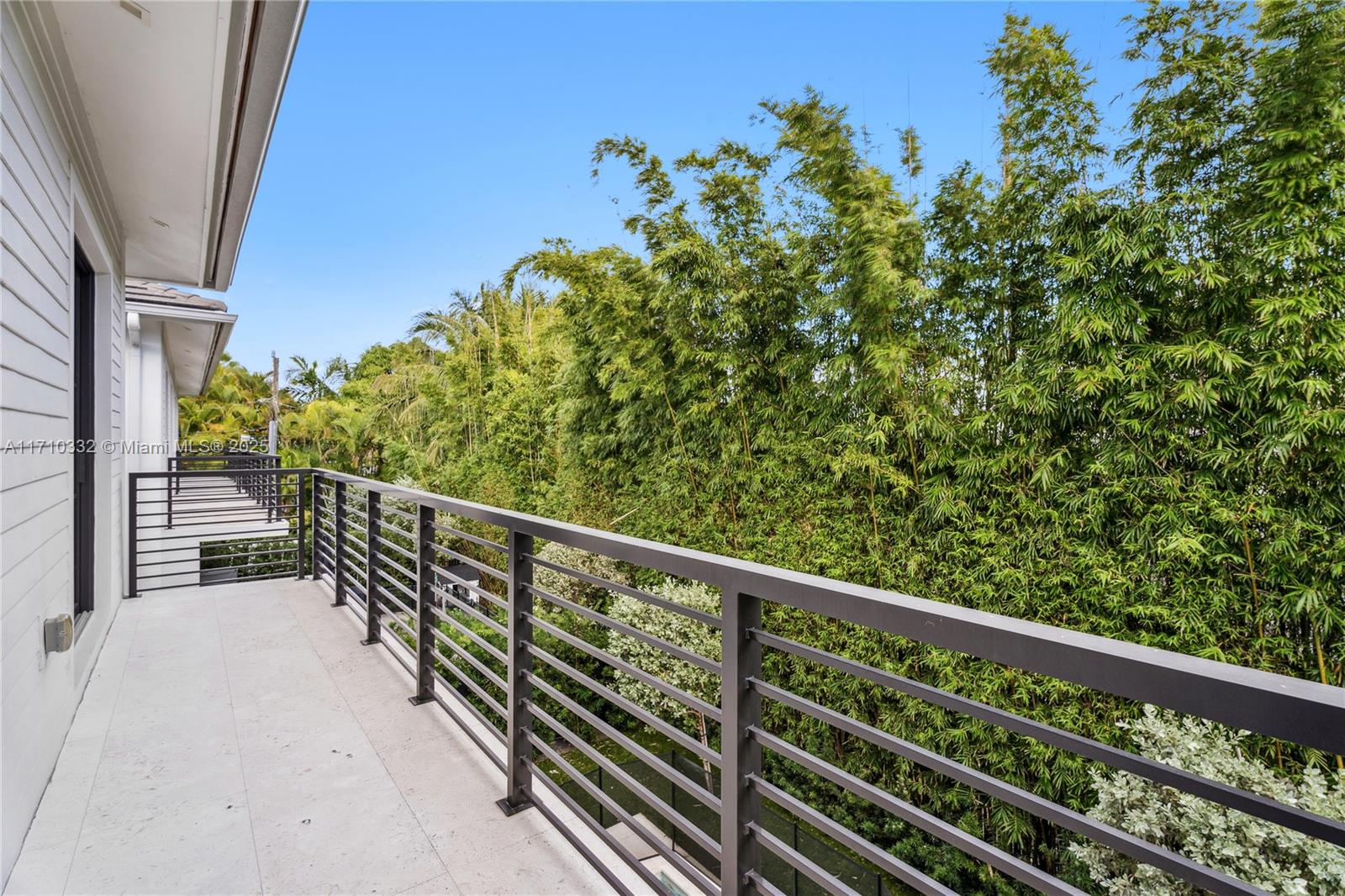 8391 Southwest 65th Avenue, Unit 8391 Miami, FL 33143 - Photo 14 of 24 a balcony with trees in front of it