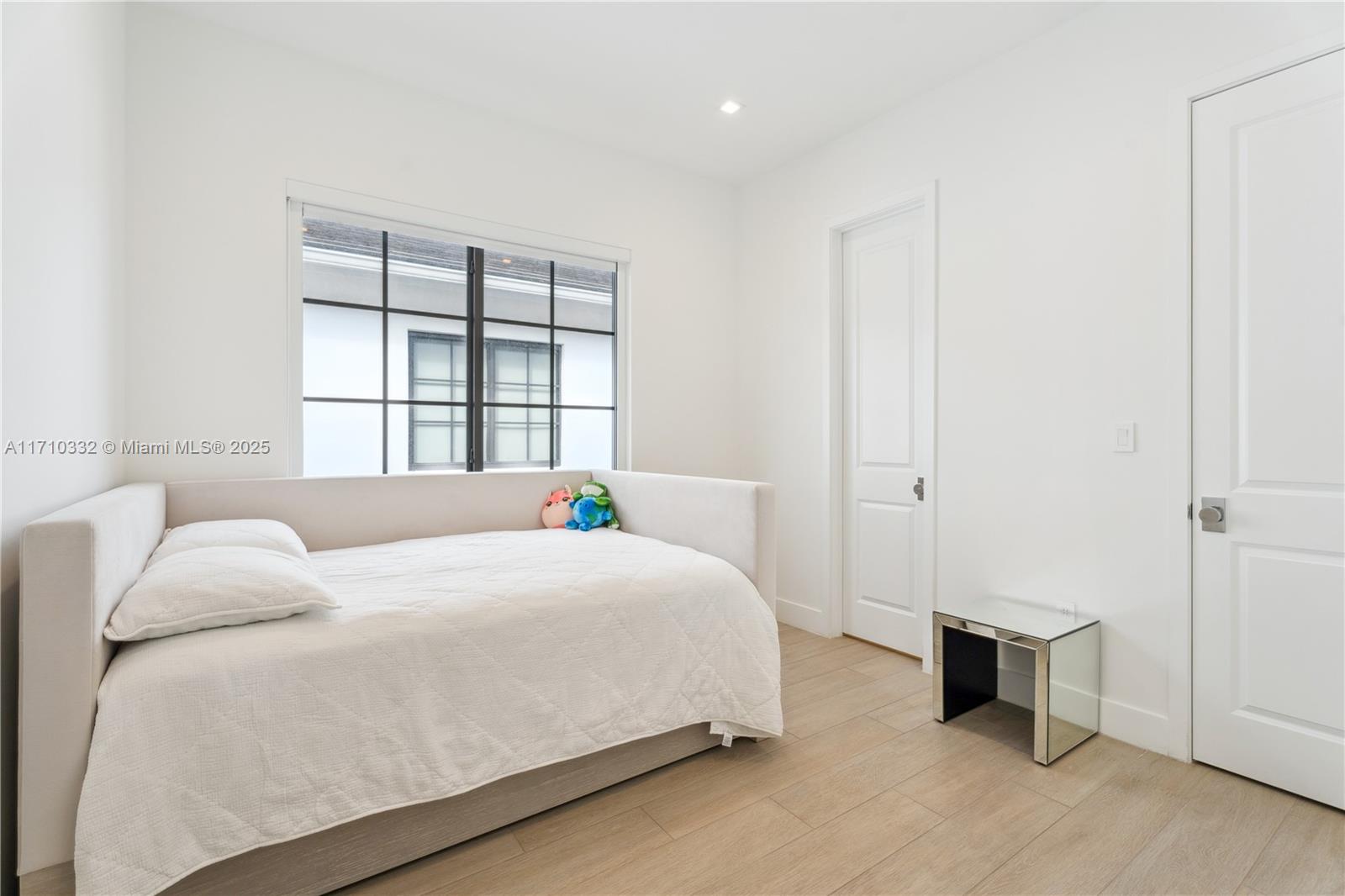 8391 Southwest 65th Avenue, Unit 8391 Miami, FL 33143 - Photo 18 of 24 a bedroom with a bed and a window