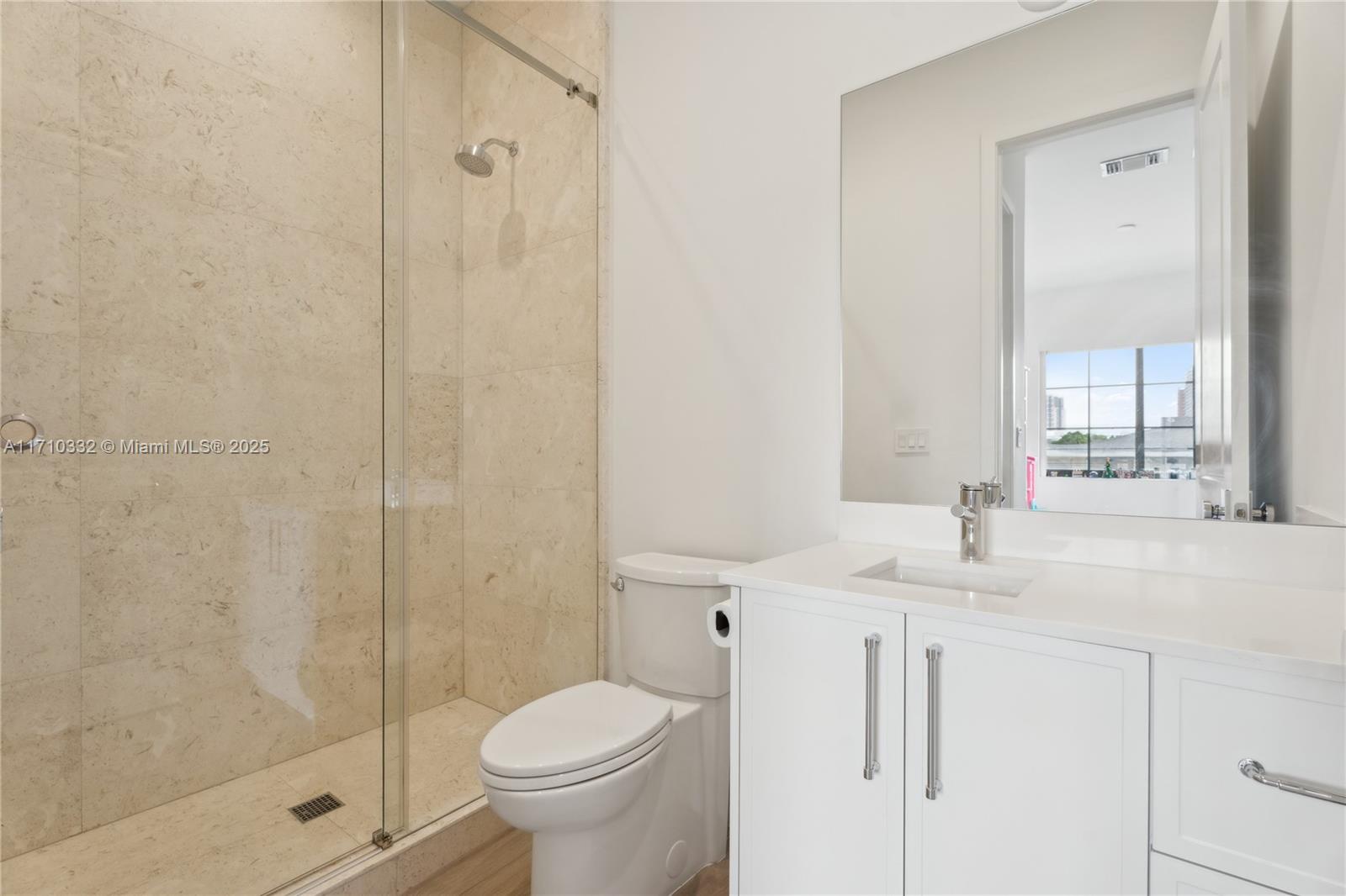 8391 Southwest 65th Avenue, Unit 8391 Miami, FL 33143 - Photo 19 of 24 a bathroom with a granite countertop sink toilet and shower
