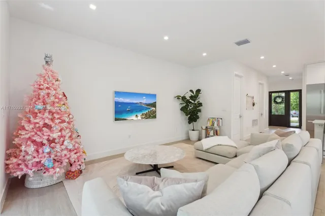 a living room with furniture and flowers