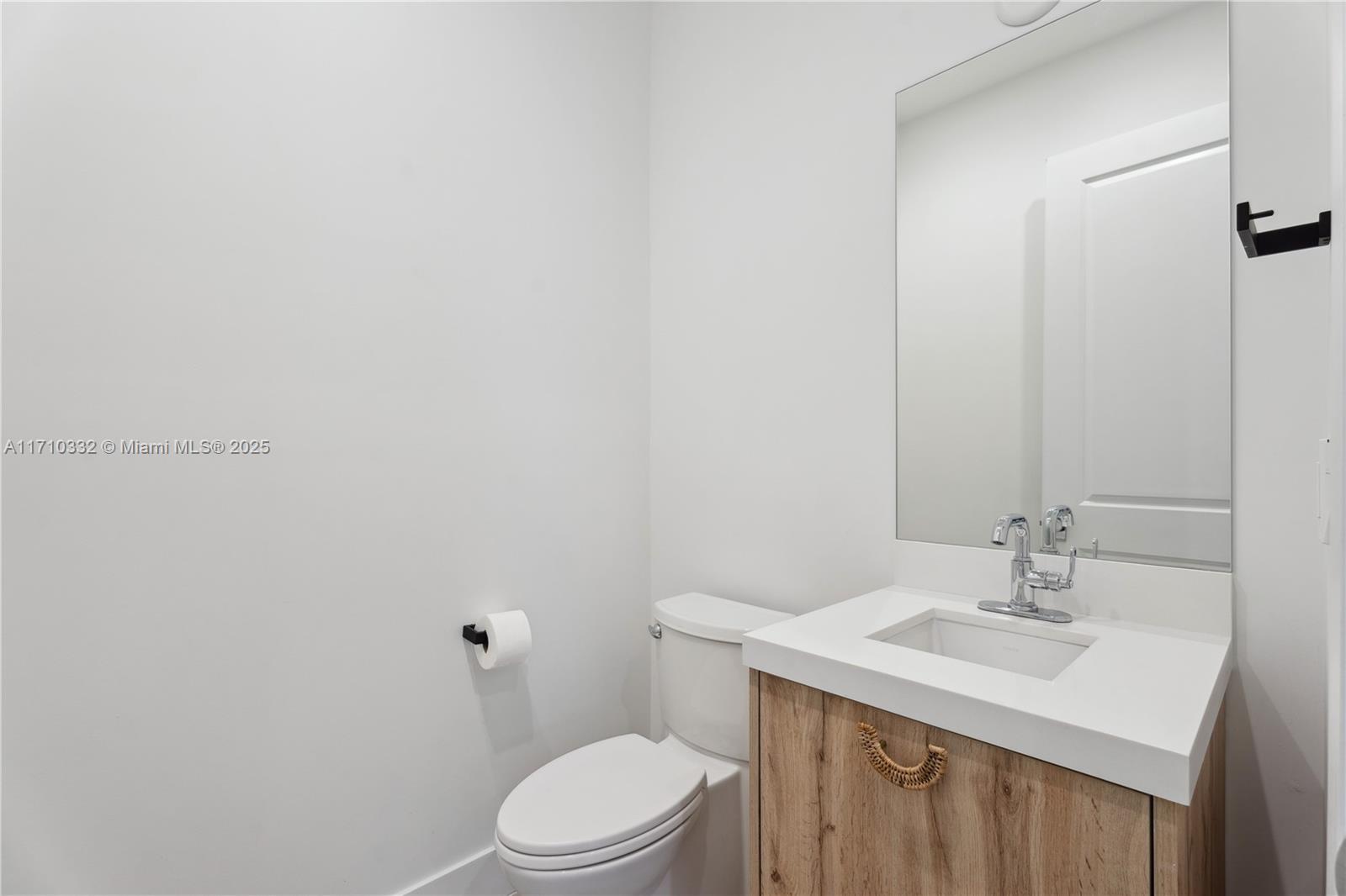 8391 Southwest 65th Avenue, Unit 8391 Miami, FL 33143 - Photo 8 of 24 a bathroom with a sink a toilet and a mirror