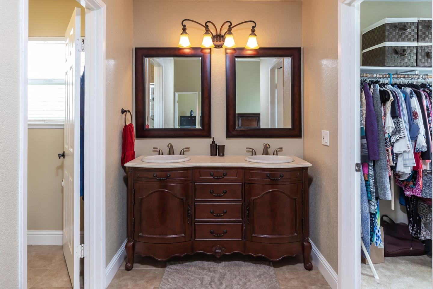 6593 Springpath Lane San Jose, CA 95120 - Photo 23 of 40 a bathroom with a double vanity sink and a mirror