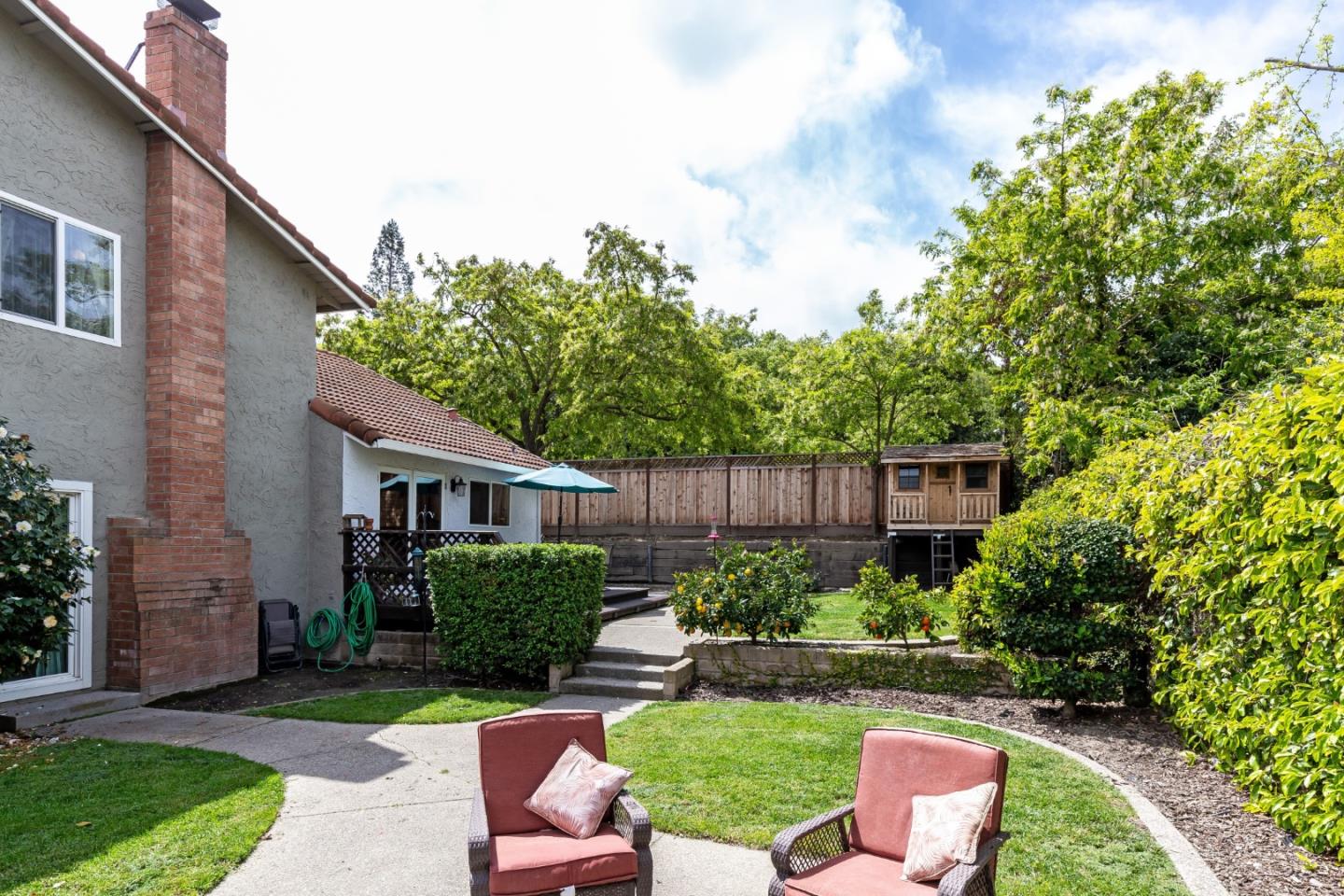 6593 Springpath Lane San Jose, CA 95120 - Photo 26 of 40 a view of a backyard with plants and a garden