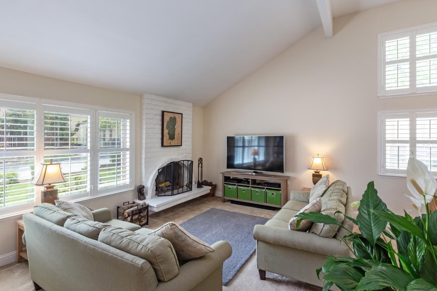 6593 Springpath Lane San Jose, CA 95120 - Photo 5 of 40 a living room with furniture flat screen tv and a fireplace