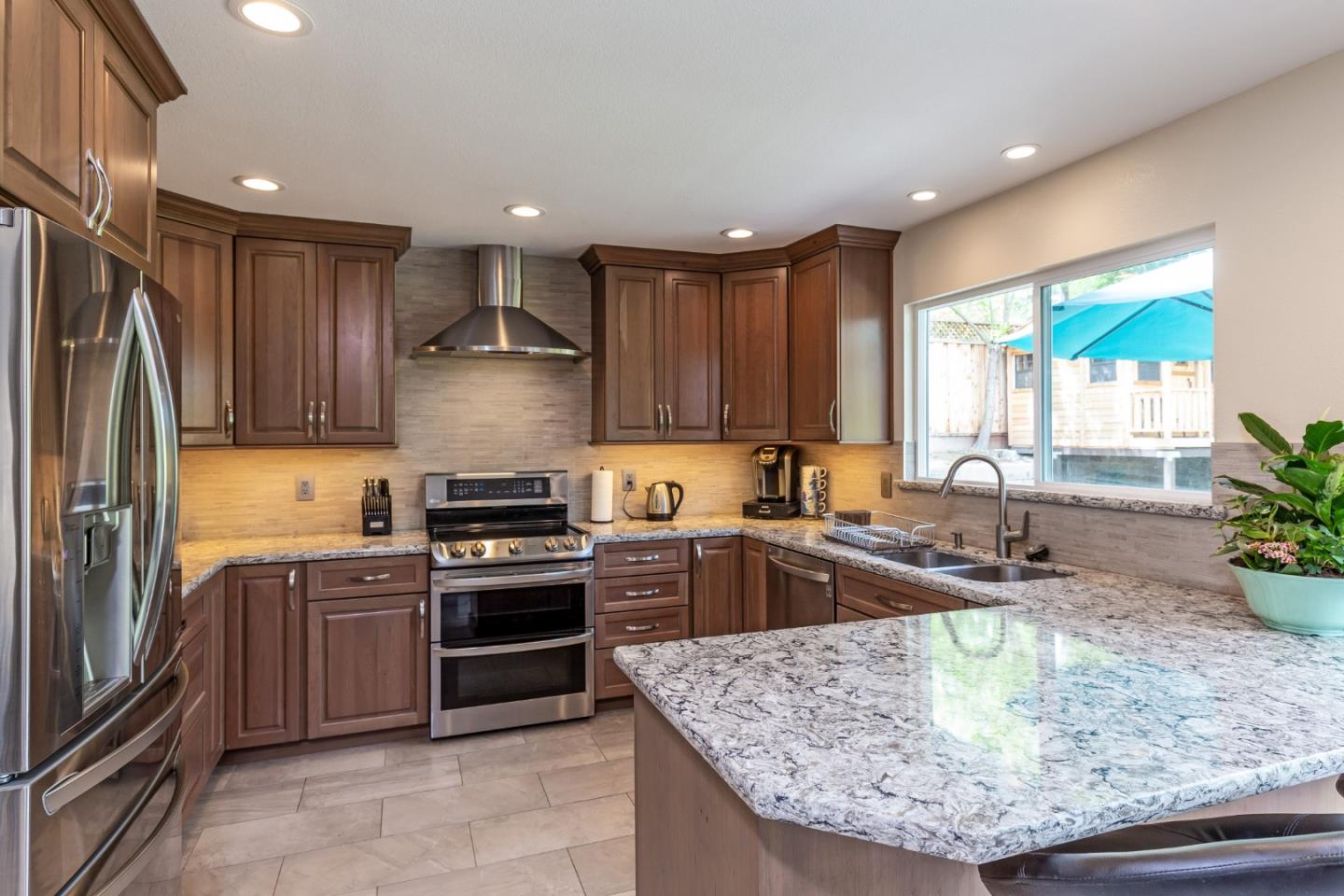 6593 Springpath Lane San Jose, CA 95120 - Photo 9 of 40 a kitchen with kitchen island granite countertop a stove sink and refrigerator