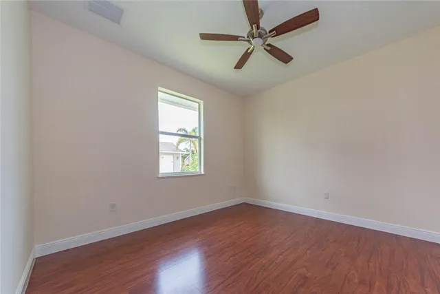 a bathroom with a granite countertop sink toilet a mirror and shower