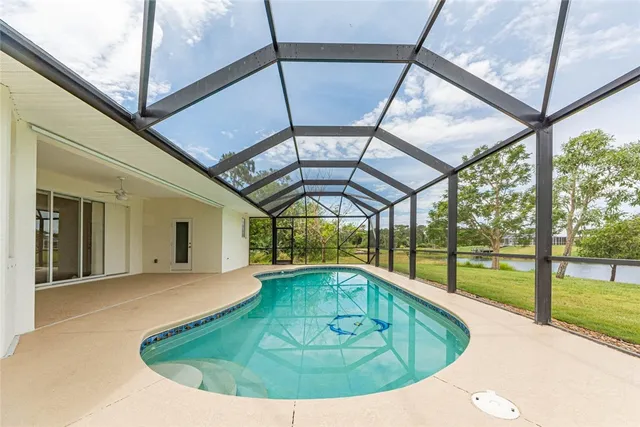 a view of an empty room with a floor to ceiling window and an outdoor view