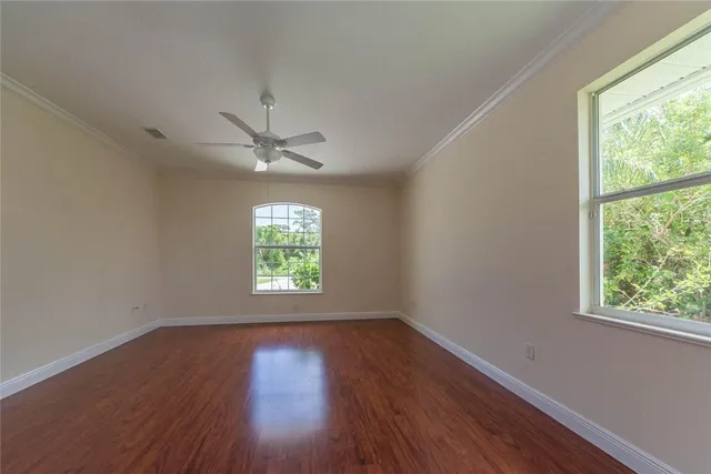 a view of a room with wooden floor and a window