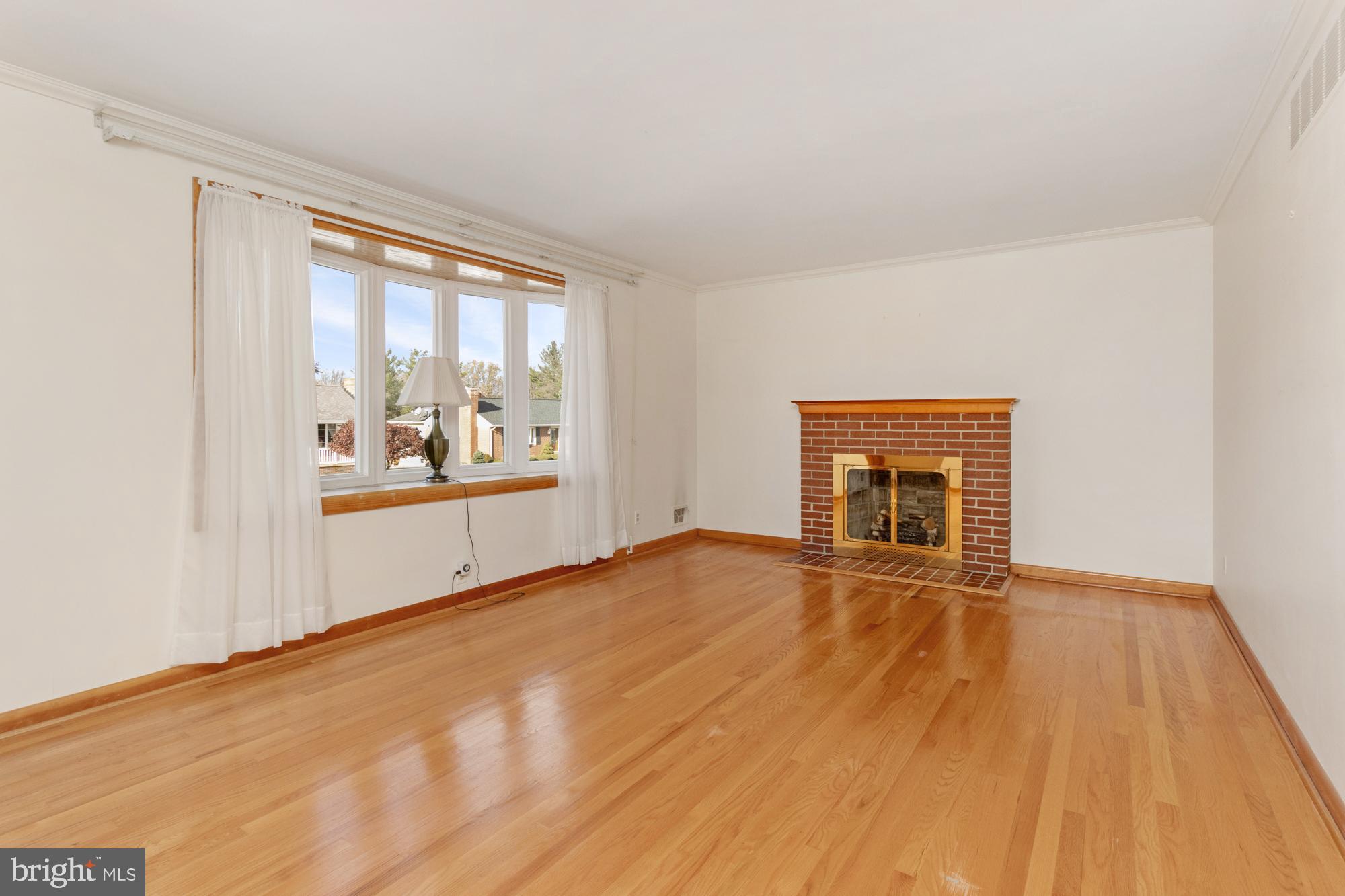 4302 Falls Park Road Perry Hall, MD 21128 - Photo 16 of 54 a view of an empty room with a window and wooden floor