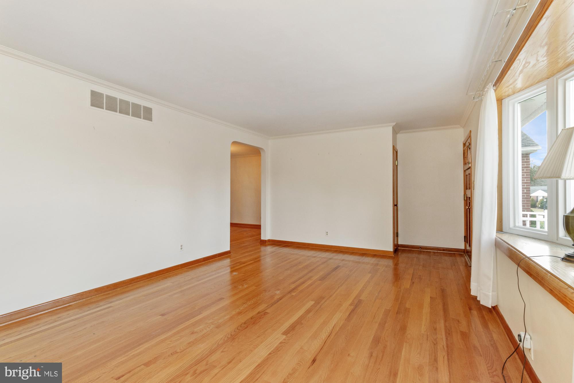 4302 Falls Park Road Perry Hall, MD 21128 - Photo 19 of 54 a view of an empty room with wooden floor and a window