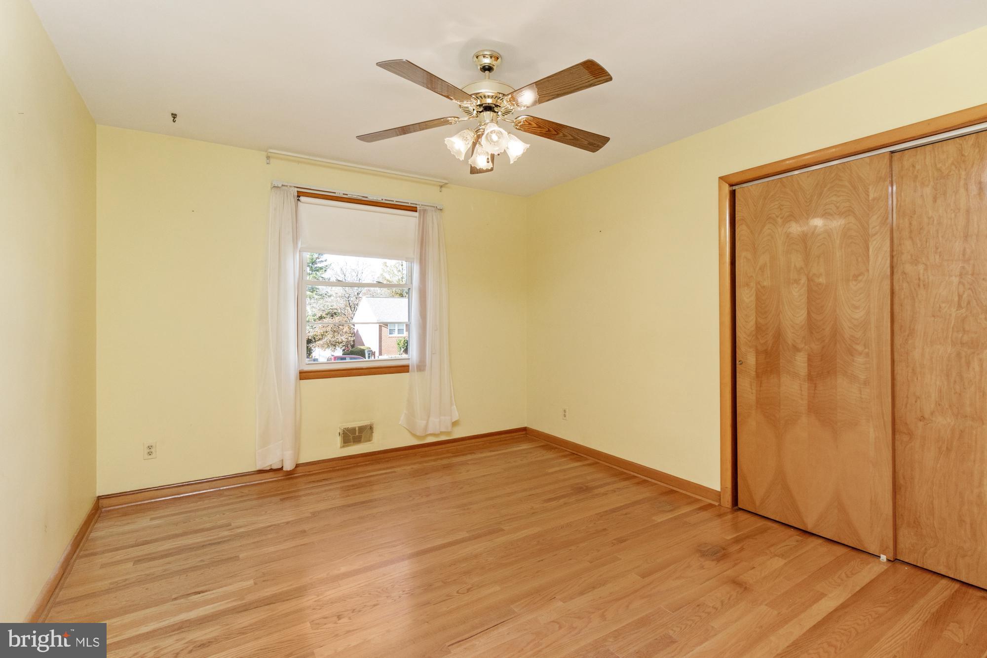 4302 Falls Park Road Perry Hall, MD 21128 - Photo 30 of 54 a view of an empty room with wooden floor and a ceiling fan