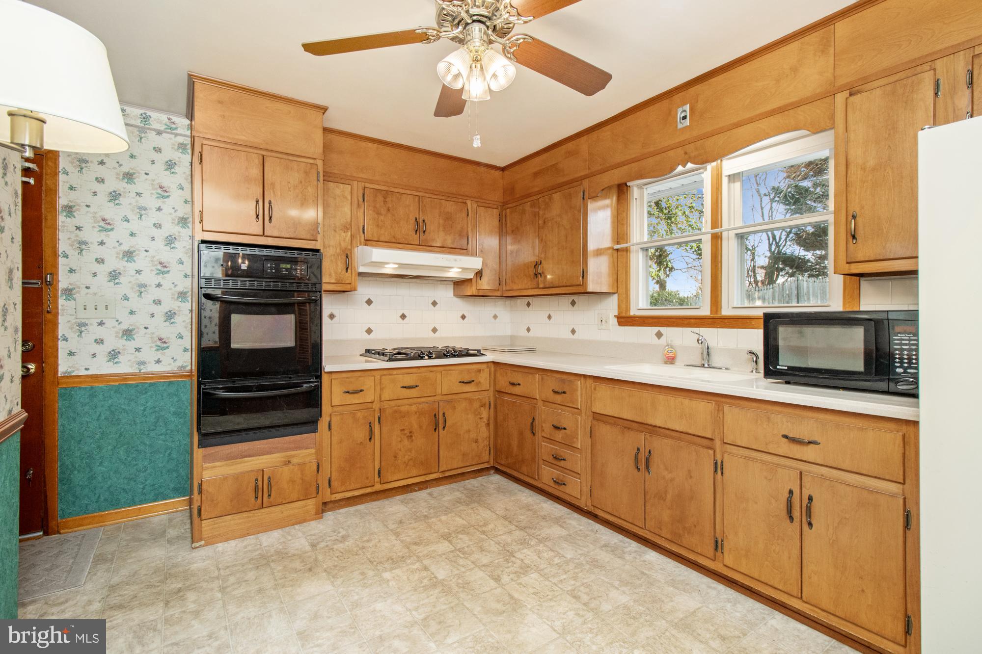 4302 Falls Park Road Perry Hall, MD 21128 - Photo 34 of 54 a kitchen with granite countertop a stove a sink and a refrigerator