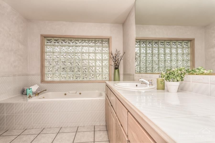 18035 North Course Lane Sunriver, OR 97707 - Photo 15 of 25 The clean, contemporary master bath has "his and hers" sides. "Hers" includes a large vanity, a deep soaking tub, shower, toilet, bidet, and a walk-in closet. The "his" side has a vanity, shower, toilet, and walk-in closet.