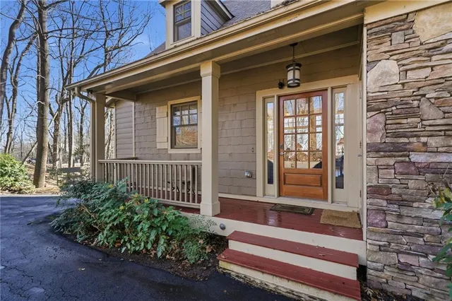 a view of front door of house with stairs