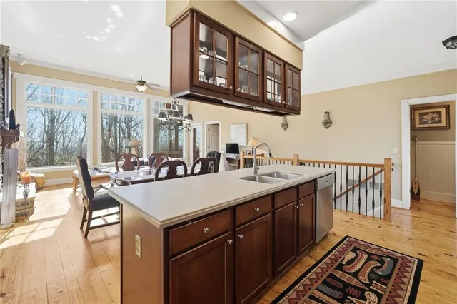 a dining room with furniture a chandelier and wooden floor