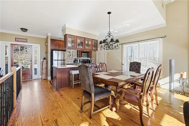 a view of a dining room with furniture and wooden floor