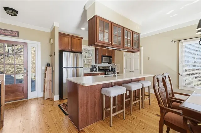 a kitchen with cabinets a refrigerator and a stove top oven