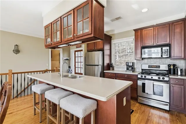 a kitchen with a sink cabinets and wooden floor