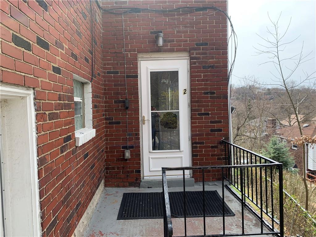 5450 Covode Place, Unit 2 Pittsburgh, PA 15217 - Photo 1 of 16 a view of a brick house with a large window