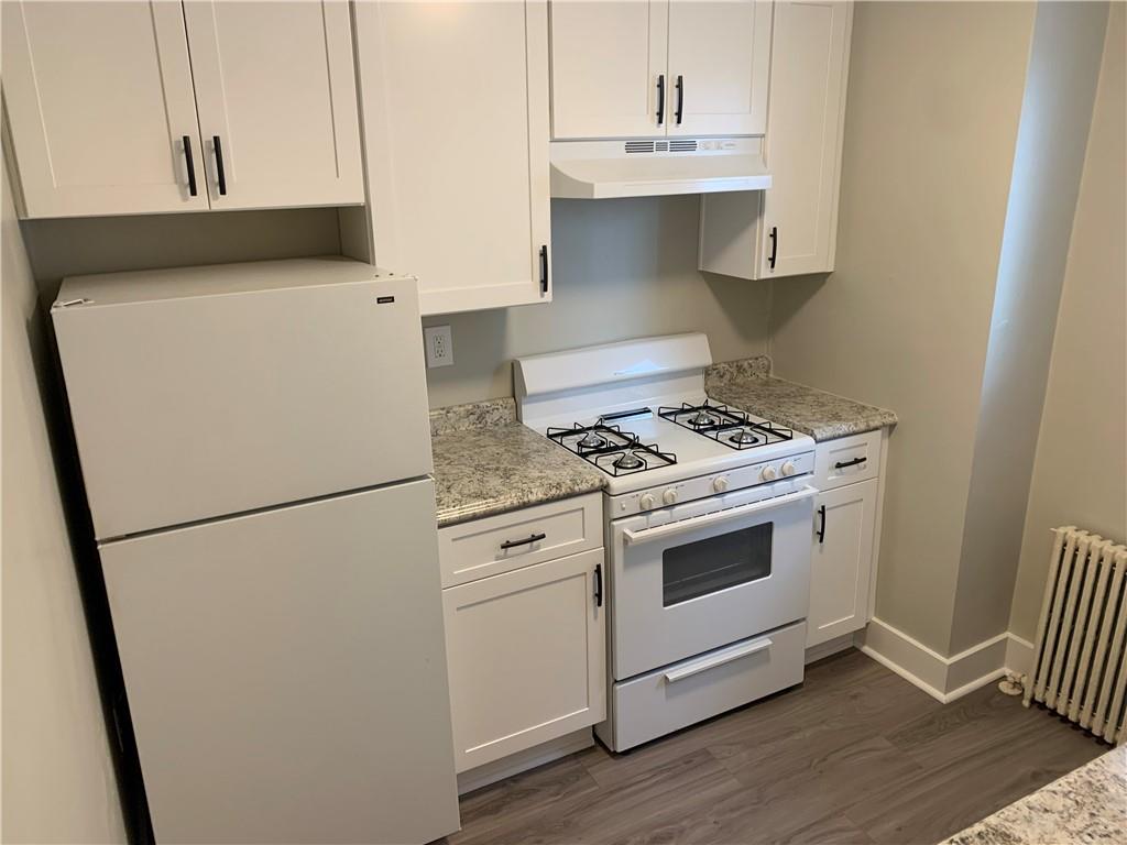 5450 Covode Place, Unit 2 Pittsburgh, PA 15217 - Photo 12 of 16 a kitchen with white cabinets and white appliances