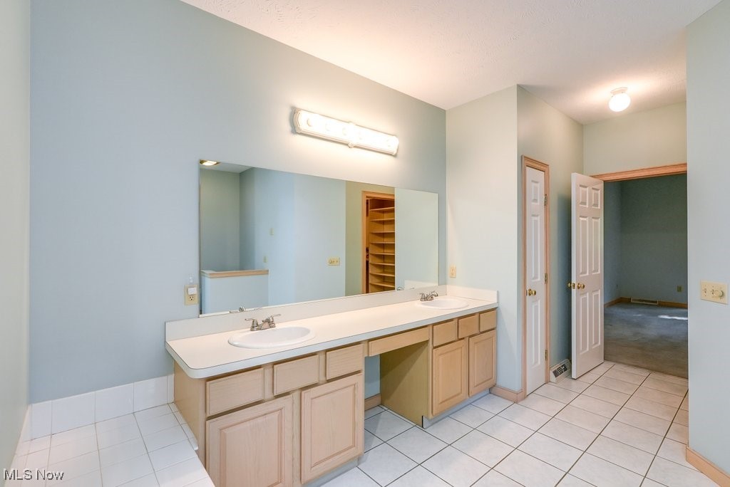 11662 Dunham Road Northfield, OH 44067 - Photo 25 of 50 Bathroom featuring tile patterned floors and vanity