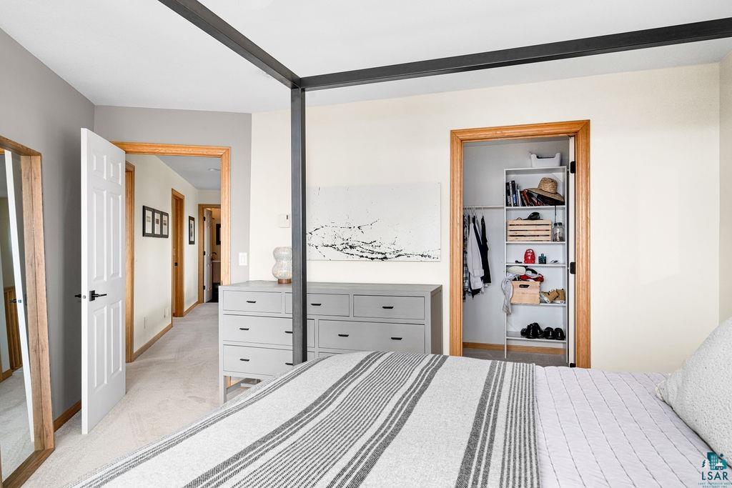4856 Kingston Street Duluth, MN 55804 - Photo 25 of 88 Neutral-toned bedroom featuring light carpeting and contrasting wood-trimmed doorways