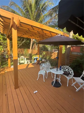 a view of a patio with wooden floor