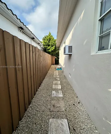 a view of a pathway gate with wooden floor