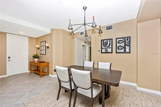 a bedroom with a bed a chair and potted plant