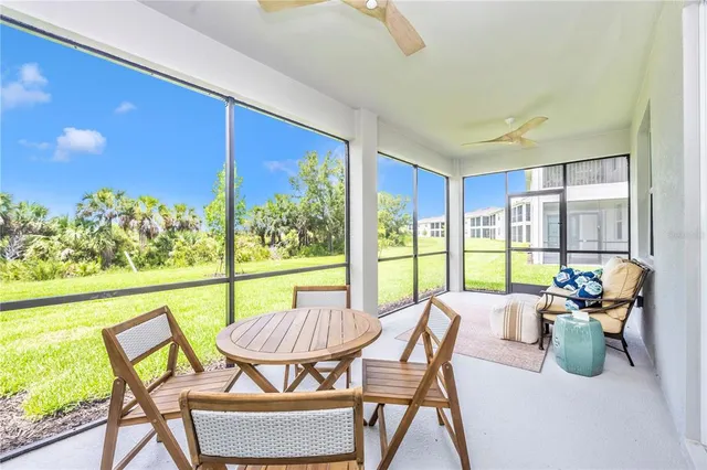 a swimming pool view with a seating space and a garden view