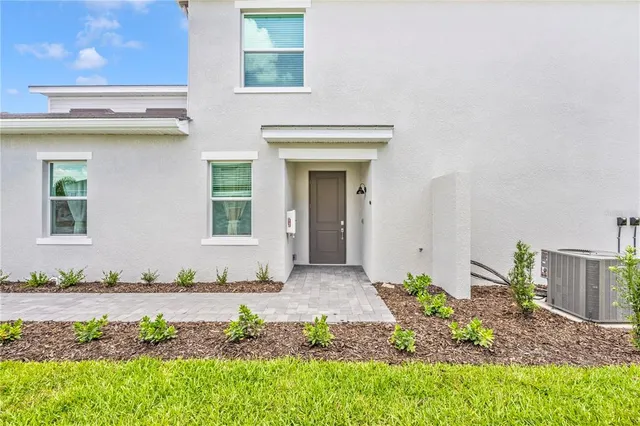 a view of a house with backyard porch and sitting area