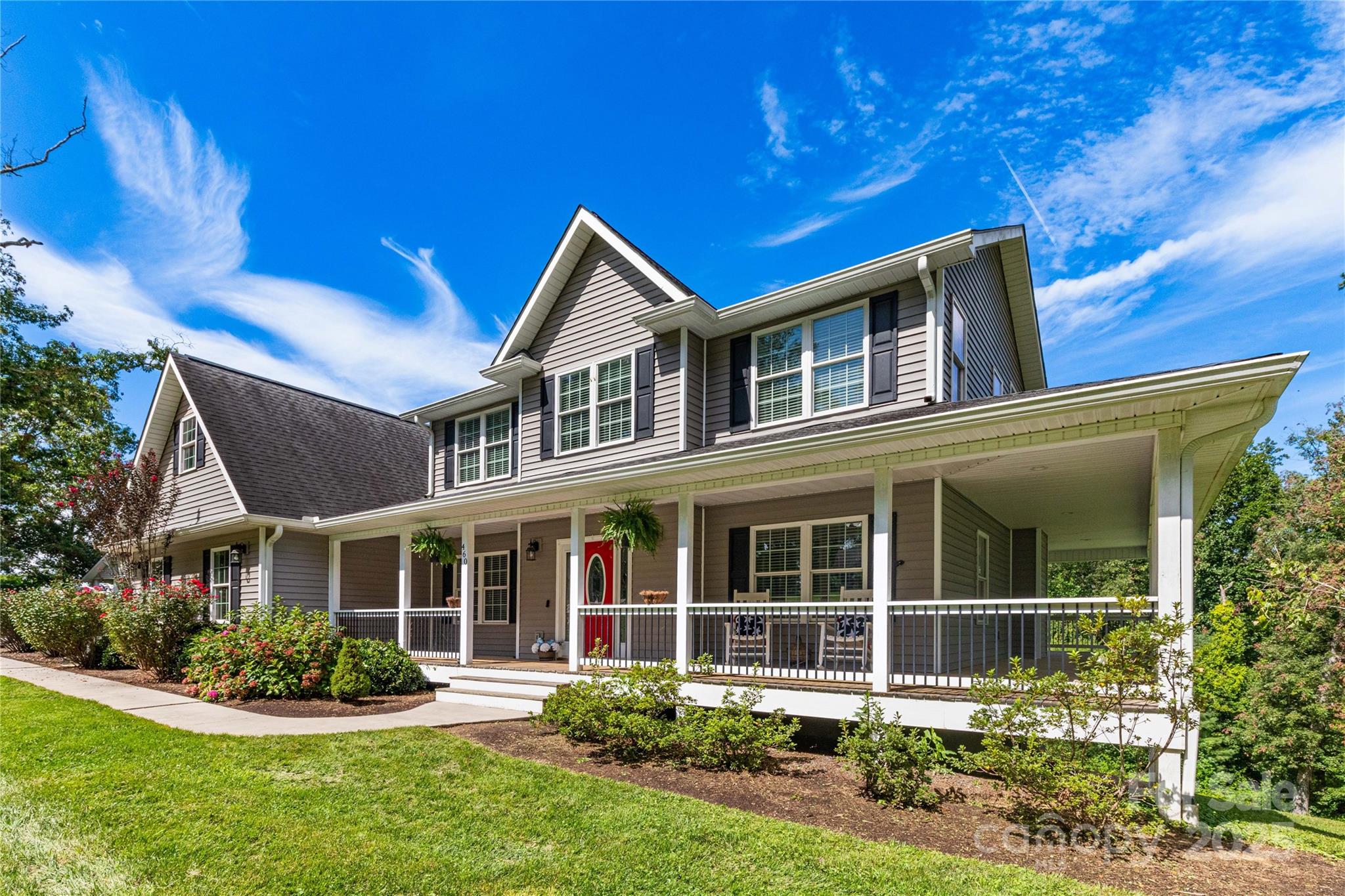 a front view of a house with a yard table and chairs