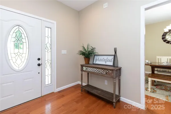 a view of an entryway with wooden floor