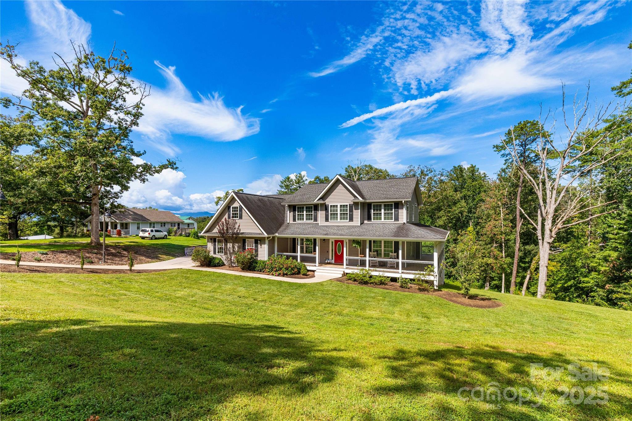 460 Panther Branch Road Alexander, NC 28701 - Photo 2 of 32 a front view of a house with a yard table and chairs