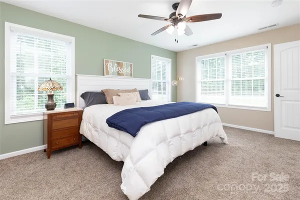 a bed sitting in a bedroom next to a window