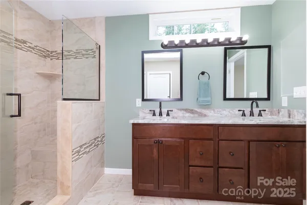 a bathroom with a double vanity sink and a mirror