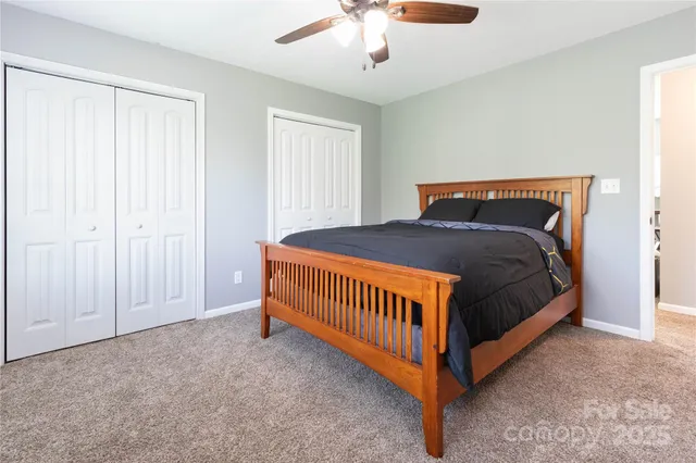 a bed sitting in a bedroom next to a window