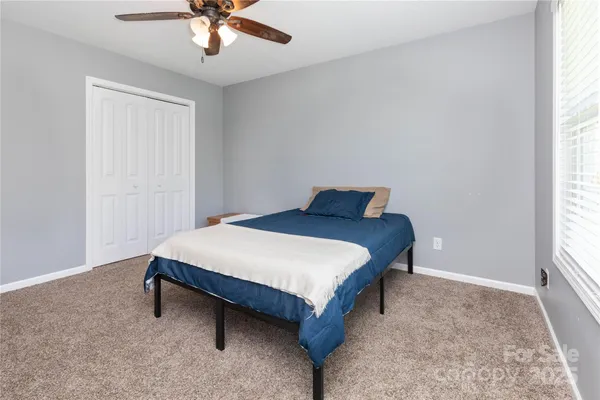 a bedroom with a bed and window