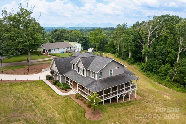an aerial view of a house with swimming pool garden view and lake view