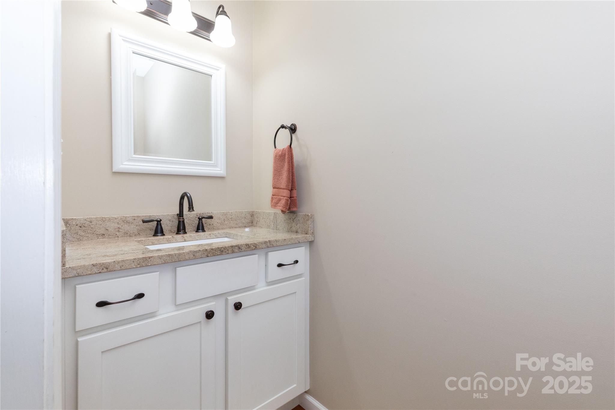 460 Panther Branch Road Alexander, NC 28701 - Photo 31 of 32 a bathroom with a granite countertop sink and a mirror
