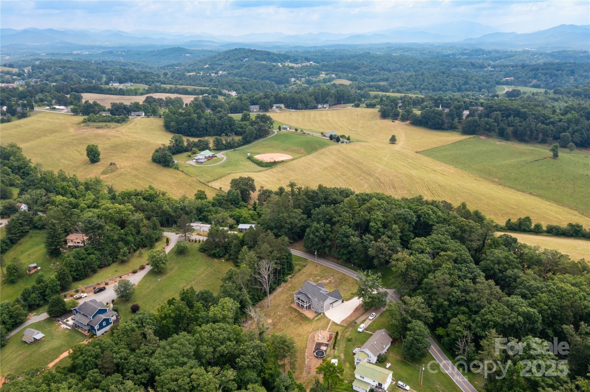 460 Panther Branch Road Alexander, NC 28701 - Photo 32 of 32 an aerial view of residential houses with outdoor space and river