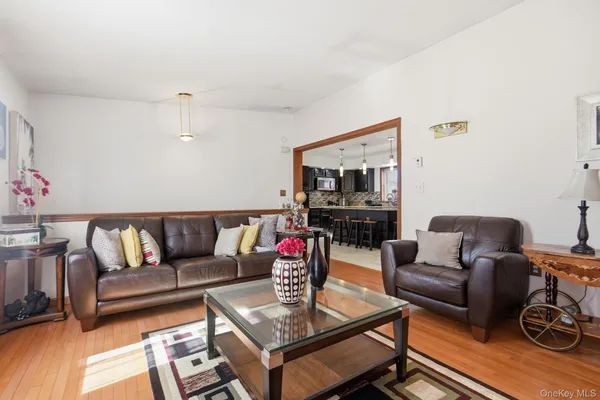 a living room with furniture a flat screen tv and a couch