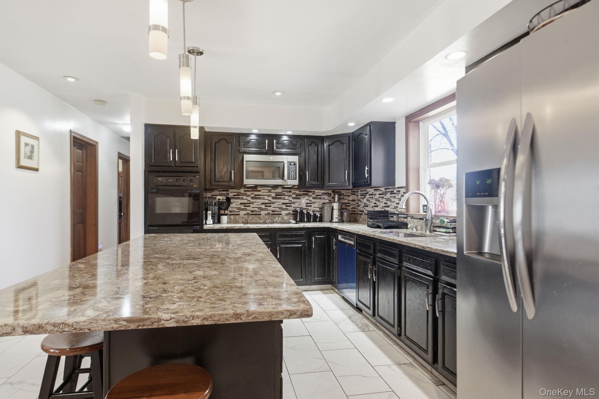 25 De Garmo Road Poughkeepsie, NY 12603 - Photo 20 of 50 a kitchen with kitchen island a counter top space appliances and cabinets