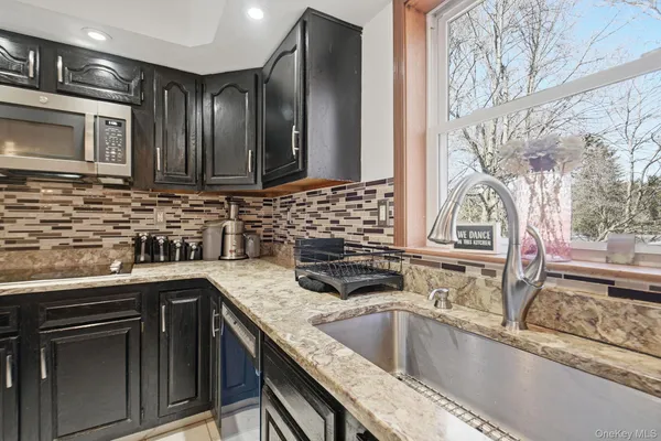 a kitchen that has a sink and a stove
