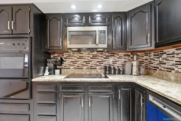 a kitchen with granite countertop a sink and cabinets