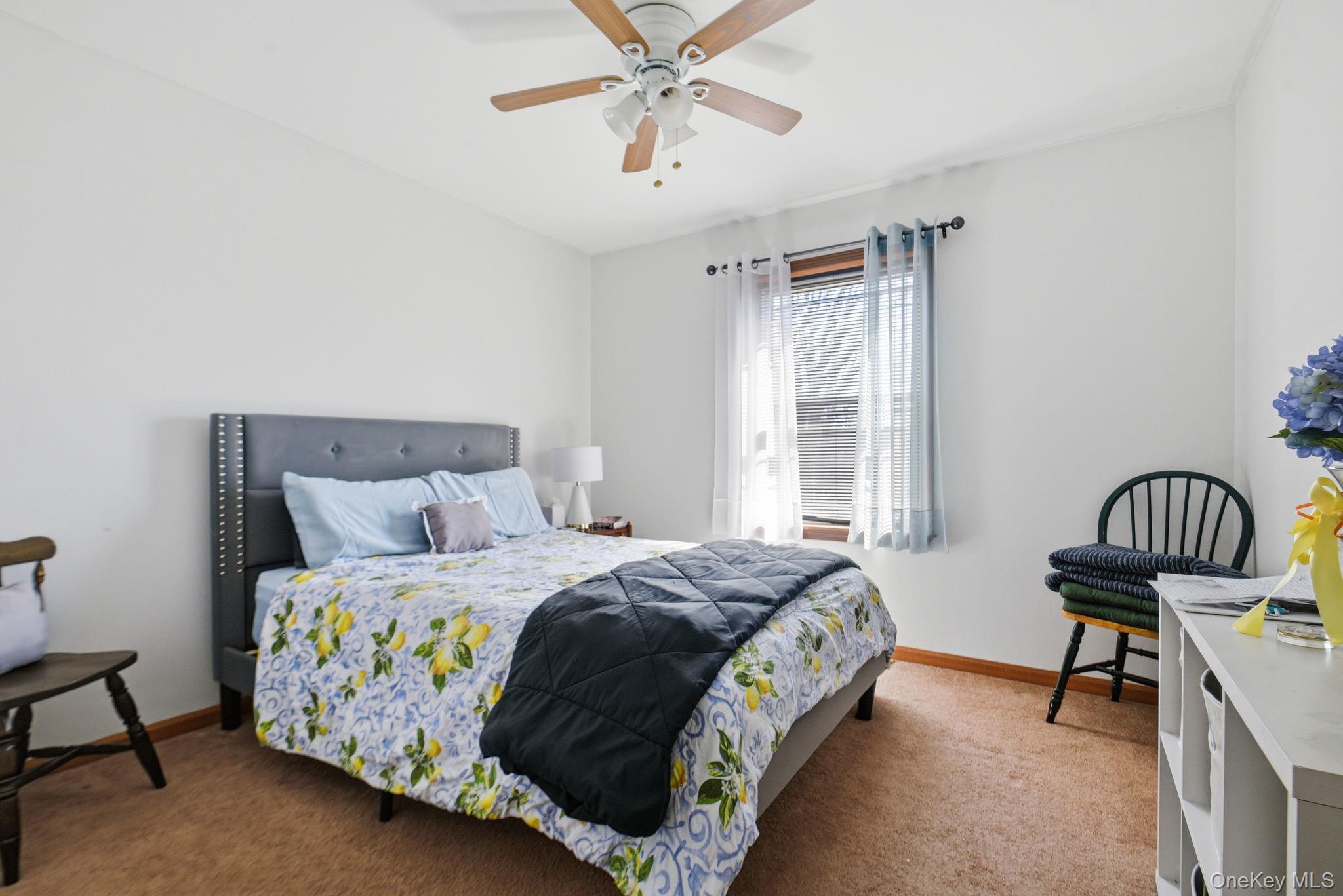 25 De Garmo Road Poughkeepsie, NY 12603 - Photo 31 of 50 a bedroom with a bed and a chandelier